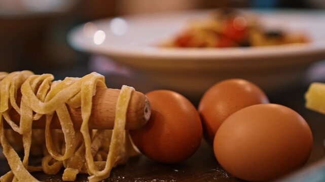 Parmesan cheese triangle wedge featured in front of a grater and fresh pasta ingredients.