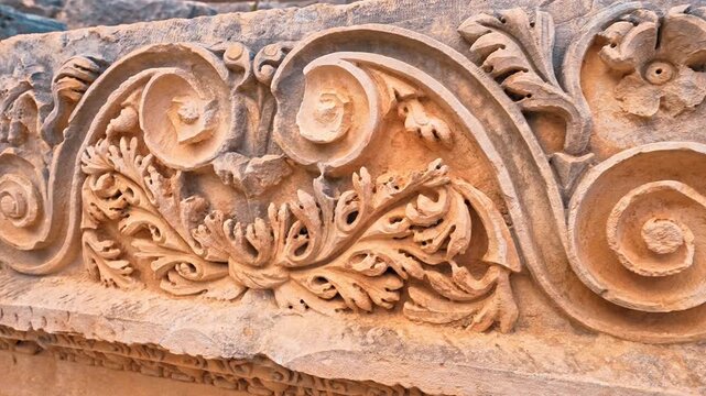 Myra Ancient City in Demre, Antalya, reveals intricate stone face carvings and ancient ruins in a detailed close up.