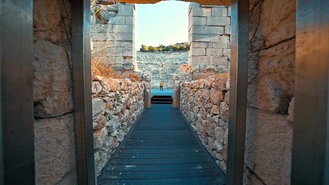 Patara Ancient City in Antalya, Turkiye, reveals its historic ruins as the camera moves forward toward a photographer.