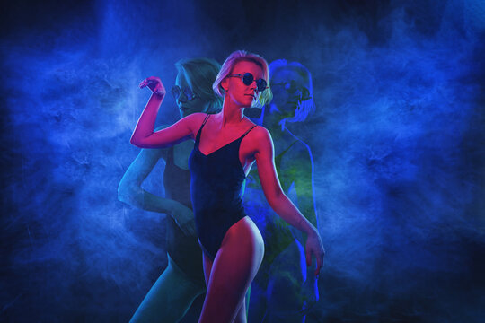 Portrait of fashion young cyber girl in virtual reality - neon light in the studio
