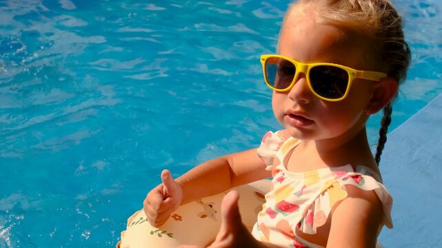 Children are swimming and playing in the pool. Selective focus.