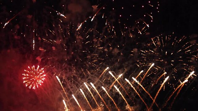 Vibrant colorful fireworks exploding in dark night sky, representing New Year celebration, Independence Day, festival event, anniversary party, pyrotechnic show, and holiday joy background concept