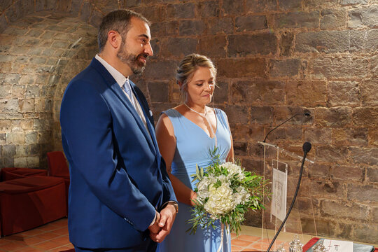 Couple at civil wedding ceremony in historic brick venue