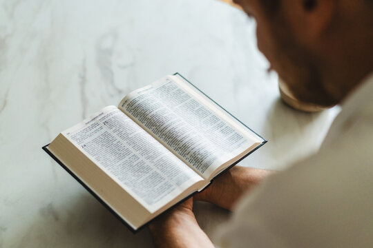 Man read Bible during private Christian prayer at home