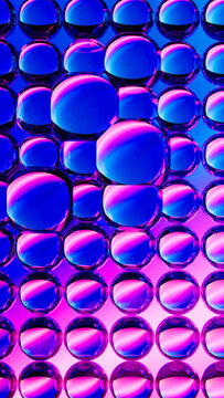 Vertical neon glass sphere pattern in blue and magenta