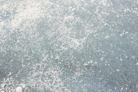 Sparkling snow crystals on a soft blue winter surface