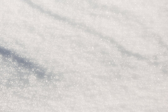 Sunlit snow texture with sparkling ice crystal background