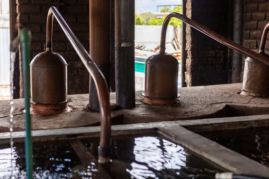 Traditional mezcal distillation in an artisanal Mexican workshop
