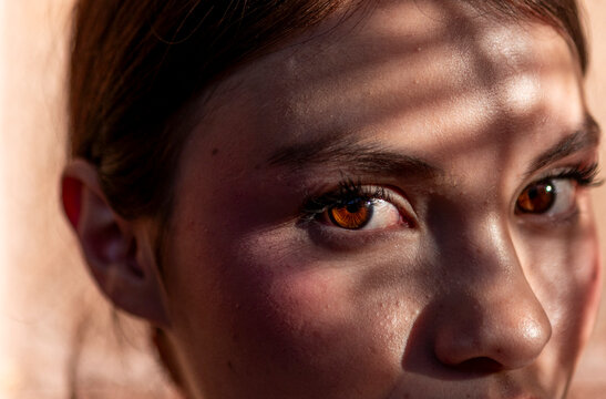 Mexican teenager with dramatic shadow across her face