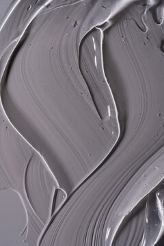 Gray cosmetic gel texture with glossy brushstroke pattern