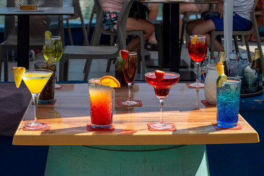Selection of vibrant summer alcoholic drinks and cocktails at a beach bar