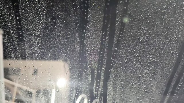 洗車機の中からの視点・ガラスについた水滴と洗車ブラシ