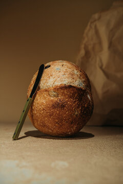 Artisan sourdough bread loaf with bread knife still life