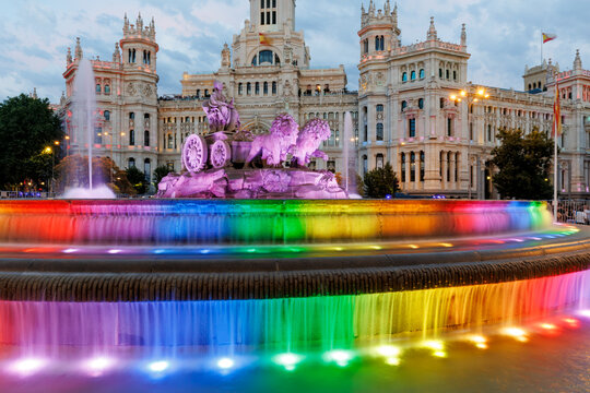 Cibeles fountain glow with rainbow lights in Madrid Spain