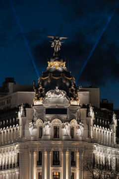 Metropolis landmark with light beam in Madrid at night