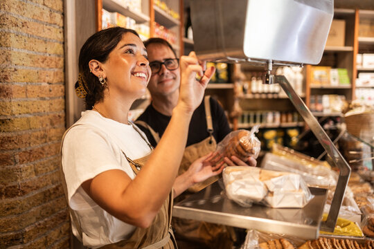 Shop owner serve customer at gourmet food store