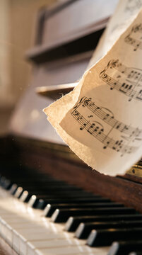 Antique Sheet Music Resting On Vintage Wooden Upright Piano