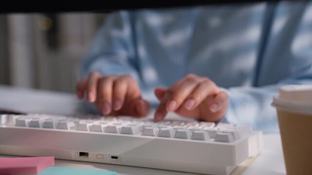 Office worker typing on a white computer keyboard at a clean desk, illustrating business data entry, digital accounting workflow, administrative productivity, and professional office technology.