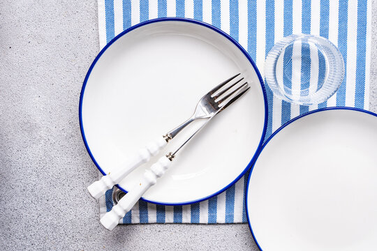 Blue and white table setting with lime and empty plate
