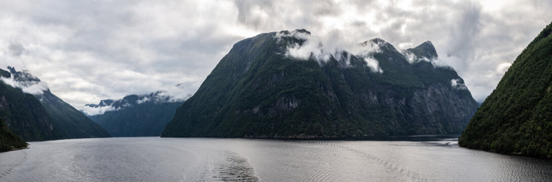 Dramatic fjord landscape with misty mountain in Norway