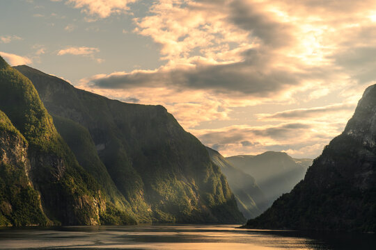 Golden sunset over dramatic fjord mountains in Norway