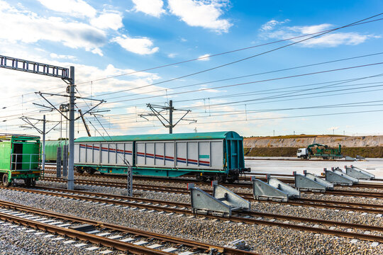 Freight train carriage at railway station under blue sky
