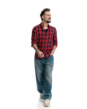Happy casual man walking and looking to the side