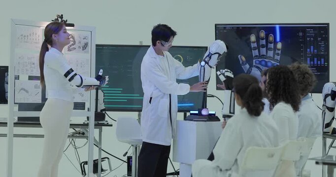 Engineers demonstrate the robotic hand gripping coloured foam objects handed up by seated colleagues, with the tactile pressure map of each finger shown on the screen behind.
