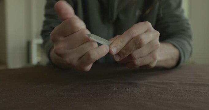 Close-up male hands do filing nails manicure. 4K 10-bit