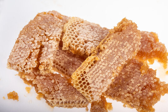 Broken Honeycomb with Fresh Honey and Hexagonal Wax Cells