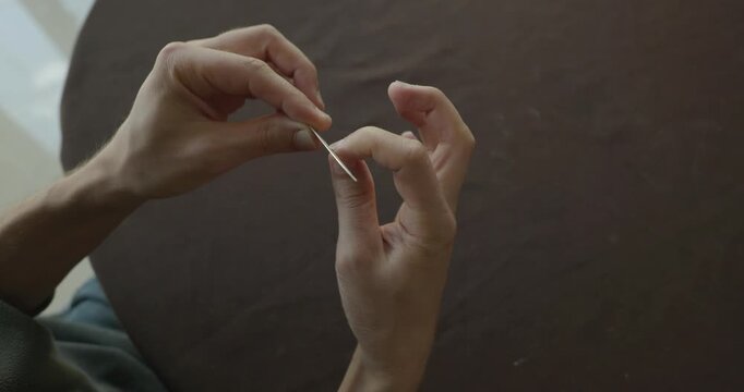 Close-up male hands do filing nails manicure. 4K 10-bit