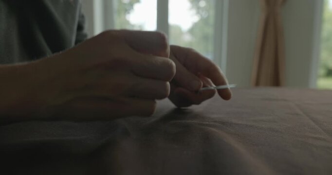 Close-up male hands do filing nails manicure. 4K 10-bit