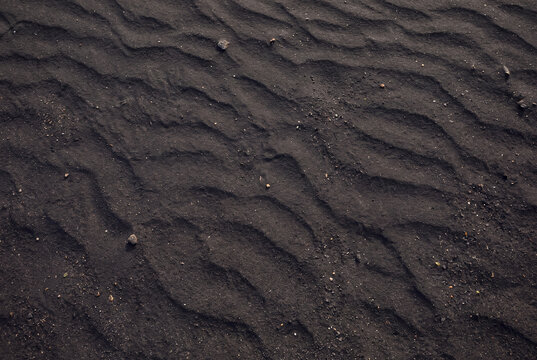 Black sand with delicate wind patterns