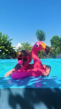 Children are swimming and playing in the pool. Selective focus.