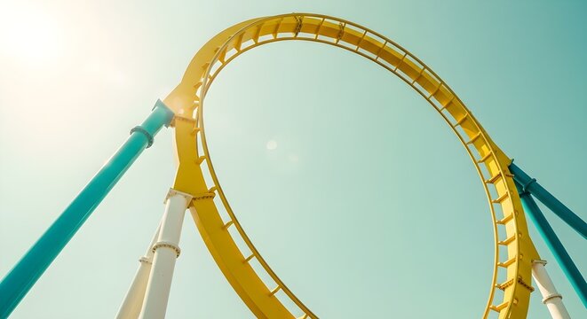Thrilling Roller Coaster Loop Yellow Track Against Bright Sunny Sky with Lens Flare ideal for travel brochures and amusement park marketing.