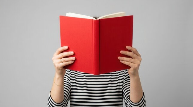 Hands holding an open book against an isolated background