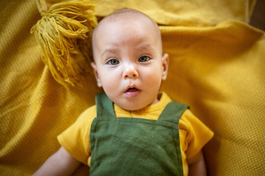 Adorable Baby in Mustard Yellow and Olive Green Outfit on a Golden Autumn Blanket