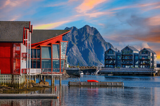 Waterfront architecture in Svolvaer harbor with dramatic mountains and colorful evening sky in the Lofoten Islands, Norway