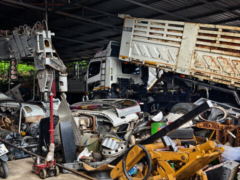 Overturned truck and crushed cars under warehouse roof