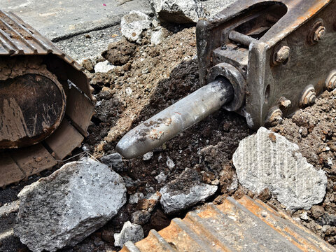 Road construction site with open trench and safety barriers