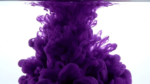 Deep purple ink cloud dissolving in clear water slowly swirling down forming abstract smoky shapes against white background isolated footage.