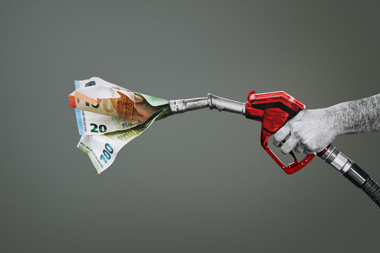 Rising fuel prices, rising oil prices.  Money is emerging from the gas station nozzle - a symbol of rising oil prices and an industrial crisis.