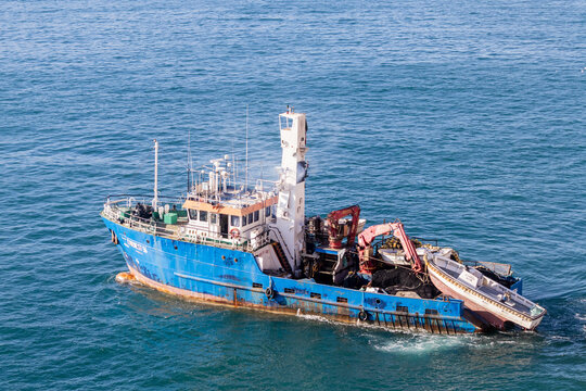 Valletta, Malta - October 14th, 2026 Blue Fishing Trawler At Sea With Workboat And Deck Machinery Operating On Calm Ocean