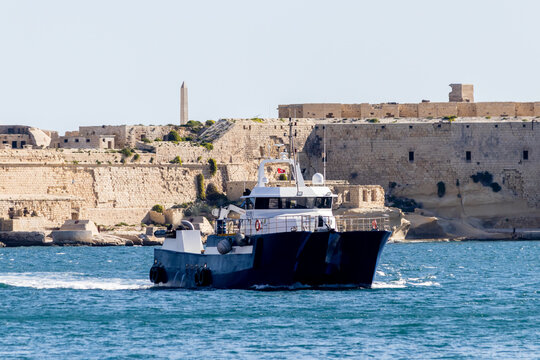 Valletta, Malta - October 14th, 2026 Commercial Patrol Boat Azure 1 Cruising Past Valletta Coastal Cityscape on a Sunny Day