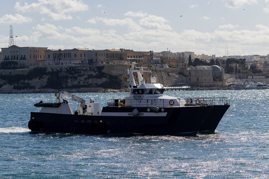 Valletta, Malta - October 14th, 2026 Commercial Patrol Boat Azure 1 Cruising Past Valletta Coastal Cityscape on a Sunny Day