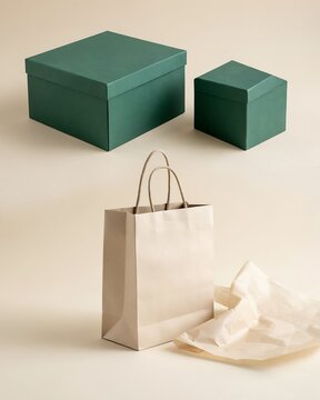 Two green gift boxes and one paper shopping bag with wrapping paper