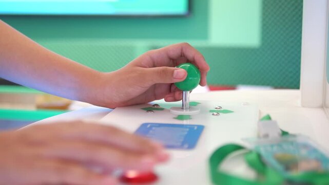 Close up of hand playing with green joystick on game controller