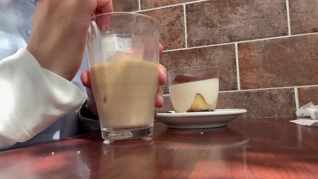 カフェでアイスコーヒーを飲む女性