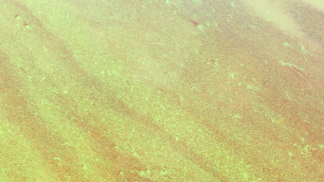 A wide blurred texture blends emerald and copper tones in soft focus today