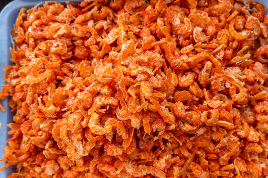 Dried orange shrimp piled in tray preserved seafood ingredient